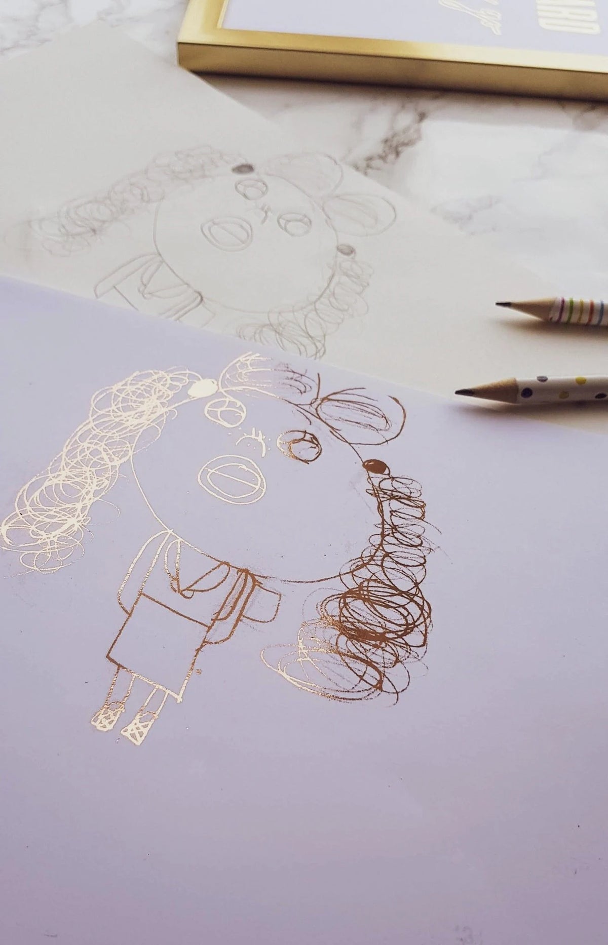 Child's drawing turned into a rose gold foil keepsake print, shown with the original